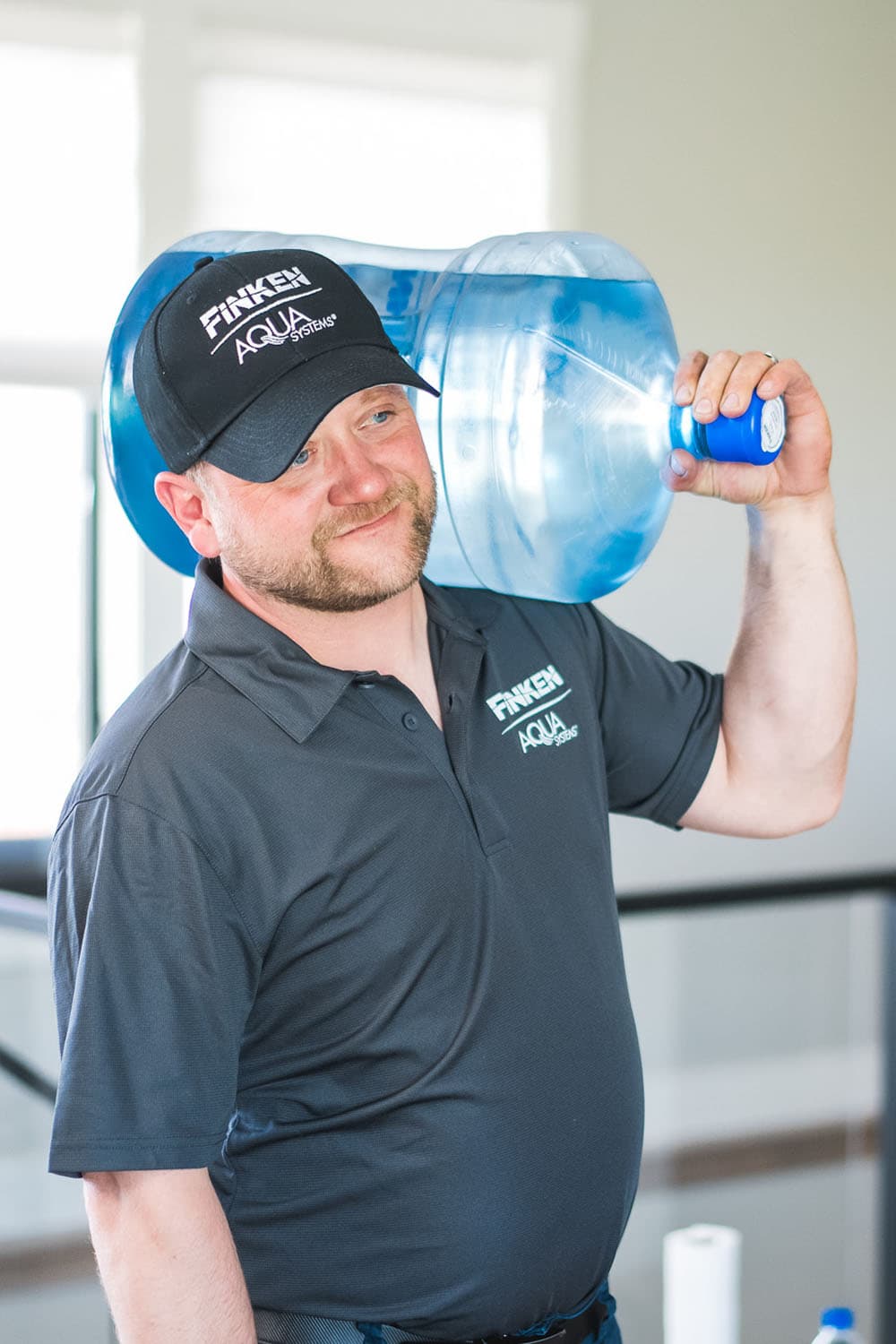 Finken team member carrying water jug